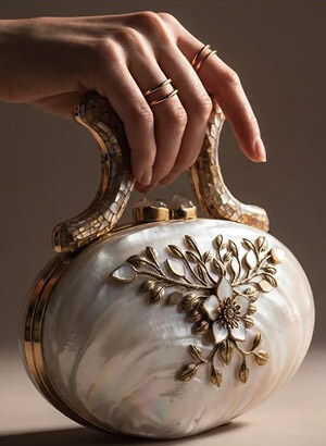 Elegant pearl clutch with floral gold detail